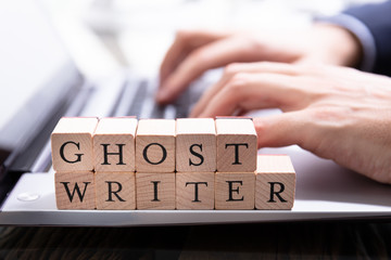 Ghostwriter Wooden Block On Computer Keyboard - obrazy, fototapety, plakaty
