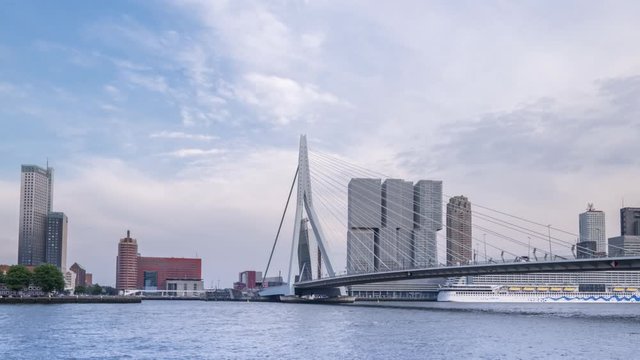 Zooming out camera of ships floating Maas river in Rotterdam, Netherlands. Amazing dutch cityscape with modern european city center with Erasmus Bridge (Erasmusbrug) and skyscrapers. Time lapse