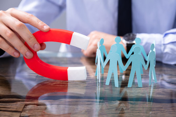 Businessperson Attracting Leads With Horseshoe Magnet