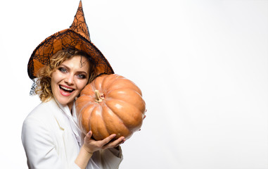 Happy Halloween Quotes and Sayings. Smiling woman in witch halloween costume with jack o lantern.Traditional food. Halloween. Girl witch with Pumpkin. Happy Halloween party. Woman with orange pumpkin.