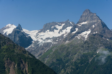 Fototapeta premium Northern great caucasus mountains near dombay with glaciers and snow in august 2019, original raw picture