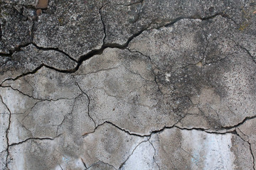 Obraz premium The old concrete wall is cracked. Urban texture. Old damaged wall. Destroyed wall texture, rough background.