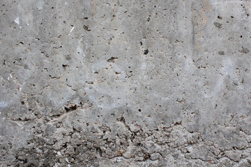 The old concrete wall is cracked. Urban texture. Old damaged wall. Destroyed wall texture, rough background.