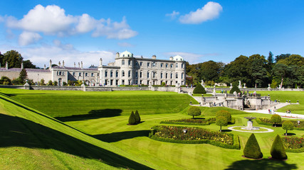 Tourists visiting Powerscourt Gardens one of the most beautiful gardens in Ireland view on mansion from terraced lawn - obrazy, fototapety, plakaty
