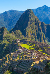 The colorful terraced fields and the citadel of the lost city Machu Picchu on top with the Huayna...
