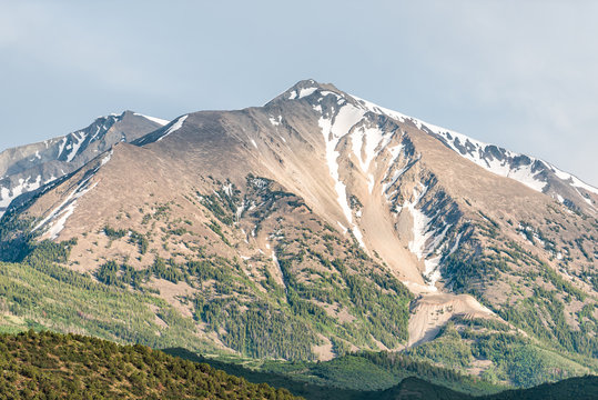 Mt Sopris mountain closeup in Carbondale, Colorado town view with snow mountain peak and sky in summer during sunset