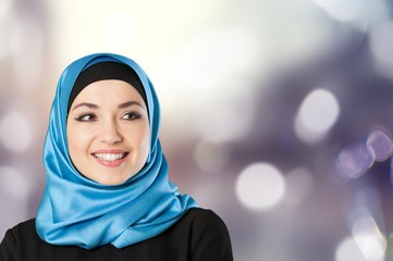 Young arabian woman on light background