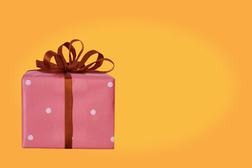 gifts in colored paper tied with satin ribbons, congratulatory, holiday concept, horizontal, close-up, copy space