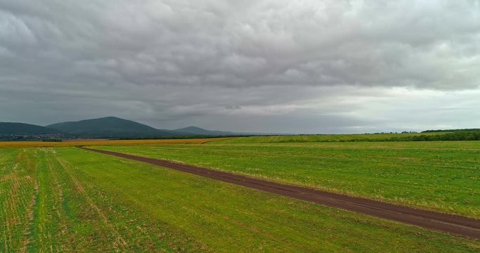 Drone view of the North Hungarian landscape of the Muzsla, part of Matra. Hills and fields of agricultural view with roads in the distance view.  Cloudy view after rain with fog in the forest.