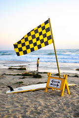 lifeguard flag swimming and surfing sign at beach coastal city