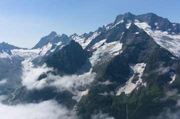 Obraz premium Northern great caucasus mountains near dombay with glaciers and snow in august 2019, original raw picture