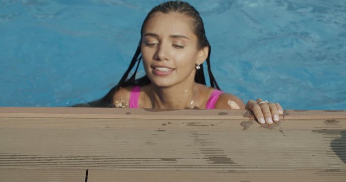 woman in bikini coming out from swimming pool