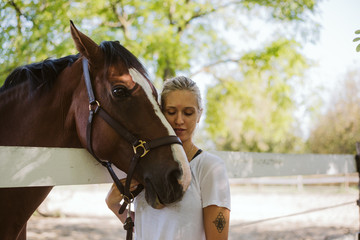 Young woman rider and her beautiful horse 