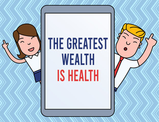 Writing note showing The Greatest Wealth Is Health. Business concept for Many sacrifice their money just to be healthy Male and Female Index Fingers Up Touch Screen Tablet Smartphone Device