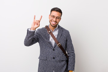 Young business filipino man against a white wall showing a horns gesture as a revolution concept.