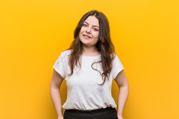 Young curvy plus size woman happy, smiling and cheerful.