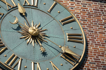 Large tower clock of the Krakow Town Hall on the background of brickwork. Krakow, Poland