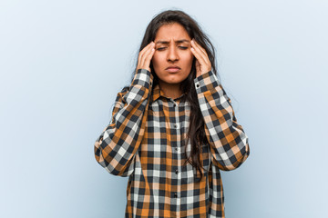 Young cool indian woman touching temples and having headache.