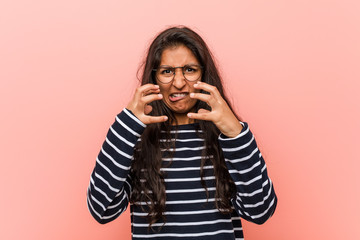 Young intellectual indian woman upset screaming with tense hands.