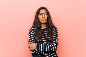 Young intellectual indian woman tired of a repetitive task.