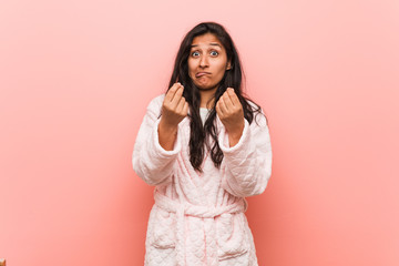 Young indian woman wearing pajama showing that he has no money.