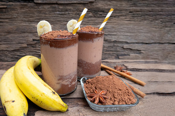 Banana blended chocolate yogurt smoothies milk high protein drinks brown put a glass on a wooden...