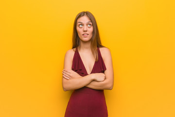 Obraz premium Young elegant woman wearing a dress tired and bored