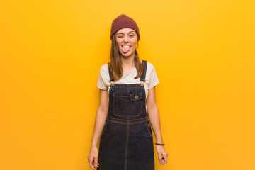 Young hipster woman funnny and friendly showing tongue