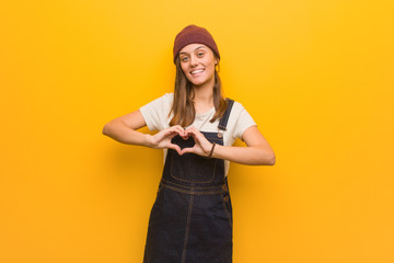 Young hipster woman doing a heart shape with hands