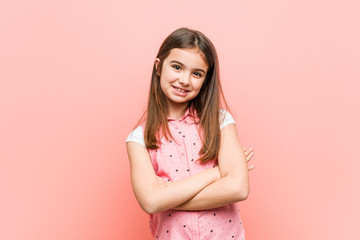 Cute little girl who feels confident, crossing arms with determination.