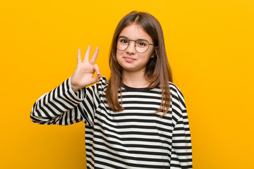 Little caucasian cute girl cheerful and confident showing ok gesture.