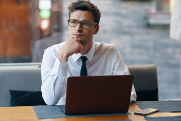 businessman working on his laptop in cafe