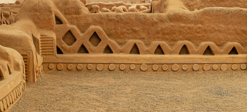 Panorama of the adobe walls and decorations in the archaeological site of Chan Chan made by the Chimu civilization near Trujillo, Peru. 