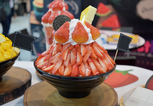 Korean shaved ice dessert with sweet toppings, Strawberry Bingsoo or Bingsu on cup.