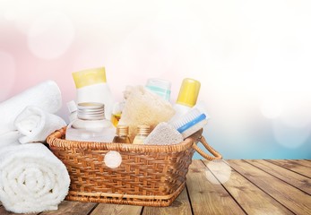 Bath towel and basket with accessories for spa on blur background