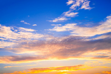  The sun reflected of the white clouds on the blue sky in the evening.