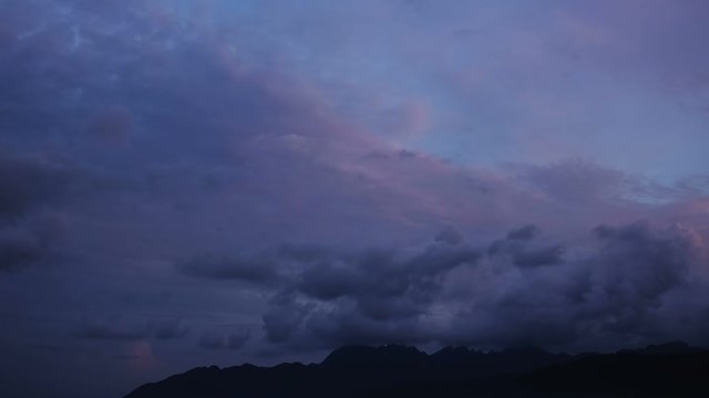 Time Lapse of Thick Cloudscape During Dusk until Early Morning Sunlight with Machinchang Cambrian Geoforest Park Langkawi in View, UNESCO Heritage