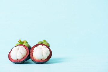 Fresh mangosteen fruit on pastel background with copy space