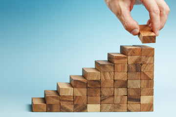hand put wooden blocks arranging stacking for development as step stair