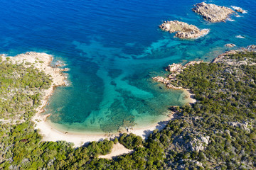 View from above, stunning aerial view of a wild beach bathed by a beautiful turquoise sea. Costa Smeralda (Emerald Coast) Sardinia, Italy.