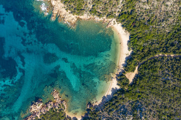 View from above, stunning aerial view of a wild beach bathed by a beautiful turquoise sea. (Emerald...