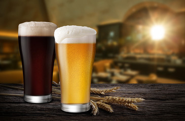 Glasses of Light Beer and Dark Beer with wheat on the bar counter in the restaurant at night, with copy space