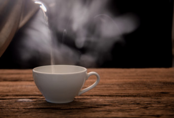 cup of hot coffee on wooden table