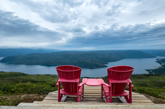 Two Red Adirondack Chairs on Top of the Lookout Trail in Gros Morne National Park Newfoundland