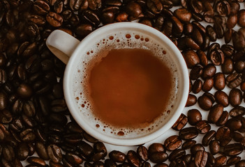 Top view of cup of coffee with coffee bean