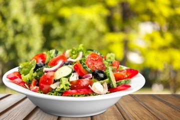Close-up photo of fresh salad with vegetables in white plate