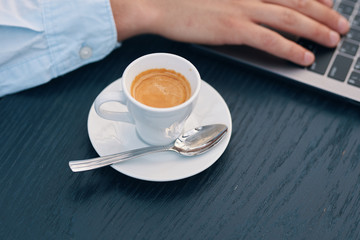 young woman holding a cup of coffee on black background
