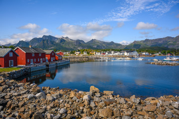 Red hut with a blue sky reflecting the water at Kabelvaag In the Lofoten Islands, northern Norway.