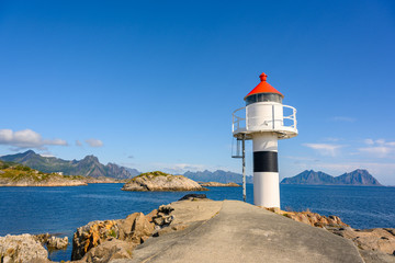 White lighthouse by the sea during the day, clear sky at Kabelvaag In the Lofoten Islands, northern Norway.