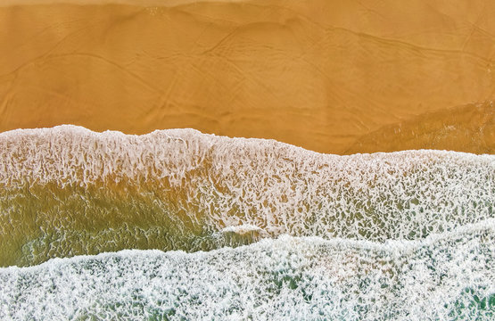 Aerial image of waves washing up on the sand